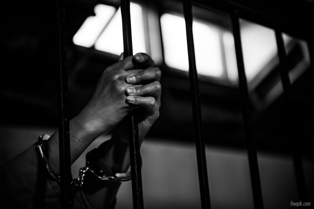 hands-women-desperate-in-prison